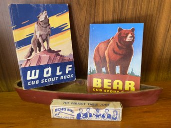 Two Scouting Books And A Little Wooden Canoe With A Bending Spoon