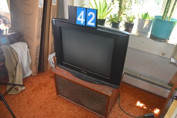 LOT 43 - TV, AND WOODEN STAND (CLOSE TO DOOR)