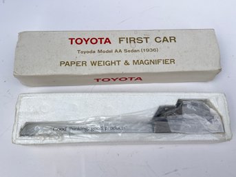 198 - VINTAGE TOYOTA FIRST CAR PAPER WEIGHT AND MAGNIFIER