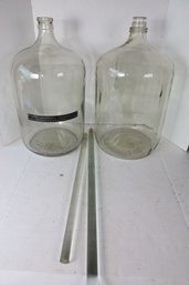 LOT 38 - TWO LARGE GLASS JUGSAND TWO GLASS RODS