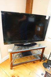 LOT 205 - TV AND STAND AND SONY PLAYER