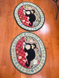 282 - TWO CAT OVAL CARPETS