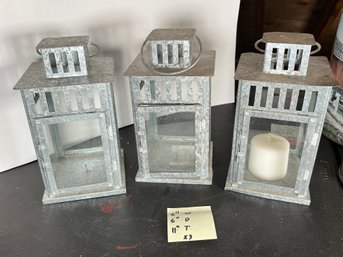 280 - THREE METAL CANDLE HOLDERS