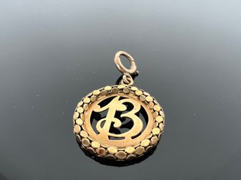 LOT 35 - GOLD PENDANT (18k / 10k)