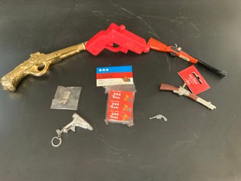 Mixed Toy Gun Lot: Lighter Rifle, Ornament, Key Chain Lighter, Hoppy Pin, Avon Pistol, Micro Mini Toy Pistol