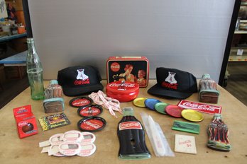 Lot Of Coca Cola Items Including Tins Hats Light Switch Cover Coasters Shoe Laces Mirrors Pen Letter Opener