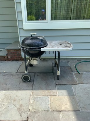 Outdoor Black Weber Charcoal Grill On Wheels