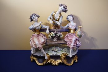 Vintage Italian Porcelain Figurine Of Group Of Three Figures On Bench In A Courtship Scene