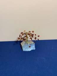 Small Bonsai Tree With Beats Leaves And Stone Base