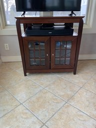 TV Stand / Entertainment Station With Glass Paned Door And Storage Within