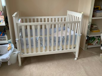 White Wooden Baby Crib On Casters