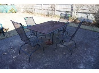 VINTAGE BLACK METAL OUTDOOR TABLE WITH 4 ROCKER STYLE CHAIRS AND UNMREBELLA STAND.