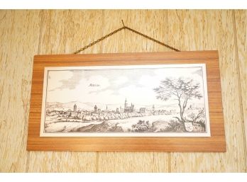 PRINT OF A VILLAGE ON A WOOD FRAME, 22X11.5 INCHES