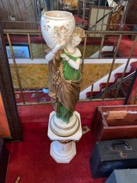 Statue Of Lady Holding Vase On A Pedestal