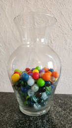 Assortment Of Marbles In Clear Glass Vessel