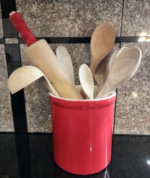 Red And White Ceramic Utensil Container Filled With Assortment Of Kitchen Utensils