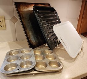 Assortment Of Kitchen Cookware Pans And Cutting Board With Rack