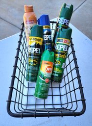 Assortment Of Insect Repellant Selections And Metal Basket
