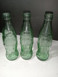 Three Vintage Coca-Cola Bottles