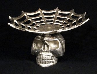 TWO SKULL-THEMED/GOTH DECORATIVE OBJECTS, INCLUDING A METAL COMPOTE AND GODINGER GLASS DECANTER