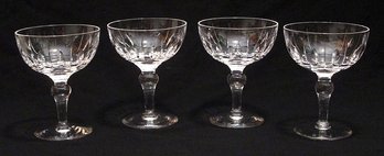 EIGHT CUT CRYSTAL CHAMPAGNES OR TALL SHERBETS IN THE 'HAMPSHIRE' PATTERN BY STUART, ENGLAND