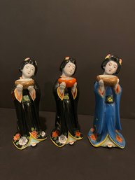 Three Japanese Porcelain Figurines Holding Bowls