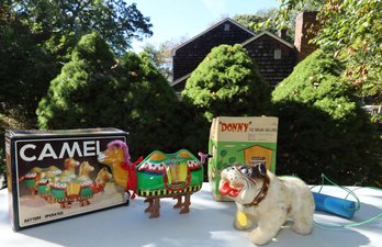 VINTAGE BATTERY OPERATED TIN CAMEL AND 1961 BULLDOG