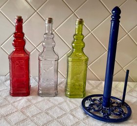 (3) Colored Glass Decanters With Cork Lids And Blue Metal Paper Towel Holder