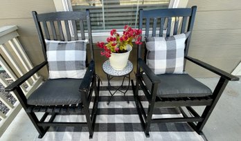 (2) Faux Wood Black Rockers With Cushions And A Mosaic And Metal Plant Stand With Planter With Checkered Rug