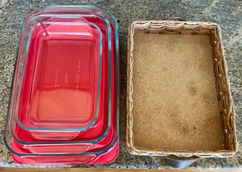 (3) Pyrex Casseroles With Red Plastic Lids And A Pyrex Wood And Leather Handled Hot Plate (as Is)