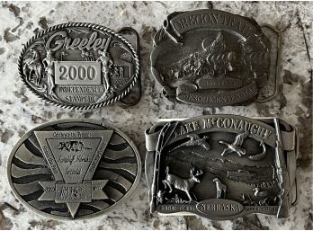 (4) Assorted Belt Buckles - 2000 Greeley Stampede, Lake McConaughey, Oregon Trail, & Scottsbluff Nebraska