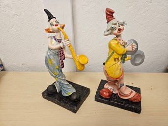 2 Clowns With Instruments One Being A Saxophone And Then A Cymbals One