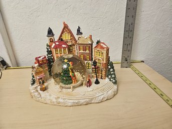 Snow Village Scene With A Snow Globe In The Middle