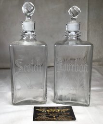 Two Engraved Scotch And Bourbon Glass Decanters With Faceted Glass Stoppers