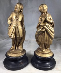 Two Antique Style Golden Figures On Black Bases
