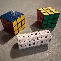 Pair Of Rubiks Cubes And Geospace Word Spin Game (HW9) (Basement Shelf)