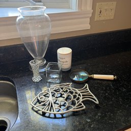 Decorative Items: Candle, Magnifying Glass, Vase, Fish Trivet (Kitchen)