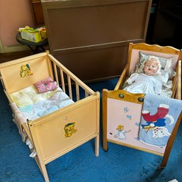 Pair Of Vintage Wooden Doll Cribs And Doll Contents: Drop Rail, One On Wheels