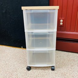 Small Plastic Three-Drawer Storage Container On Casters With Faux Wood Top (Basement)