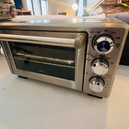 Oster Counter Top Toaster Oven  (Living Room On Table Left Side)