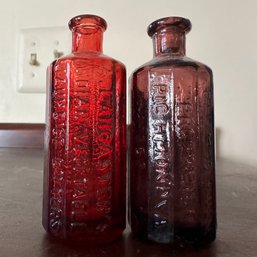 Pair Of Small Red & Purple Toned Vintage Embossed Bottles, 'Jaundice Bitters' (LR)