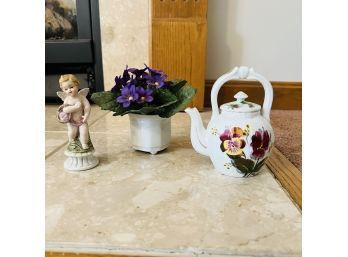 Small Teapot, Faux Violets In A Pot And Cherub Figure