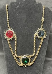 VINTAGE 16 INCH FAUX SAPPHIRE, EMERALD AND RUBY MEDALLION BELT