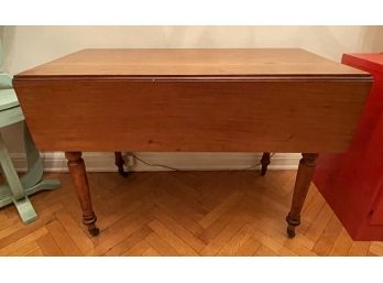 VINTAGE OAK DROP LEAF DINING TABLE WITH SINGLE DRAWER AND BRASS WHEELS