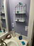 R9 Entire Contents Of Bathroom. Includes Small Table, Stool, Baskets, Lamp, Coral, Mirror, Wall Storage, Showe