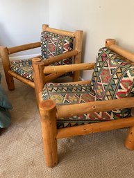 A Pair Of Hand-hewn Pine Chairs From Chicken And Egg Collection With Decorative Cushions. Located Upstairs