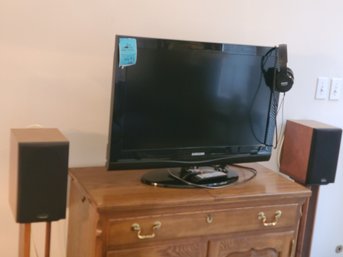 31in Samsung TV With Remote, Two 32in Polkaudio Speakers With Stands And Philips Headphones.