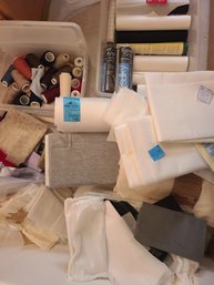 Various Rolls And Pieces Of Fabric, Thread And Other Sewing Supplies