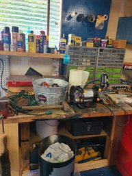 Craftsman Bench Vise Bolted To The Table, Bench Grinder, Car Jack, Plastic Organizer, Screws, Bits