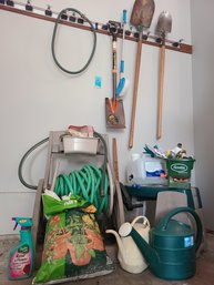 Gardening Tools, Gloves, Water Cans, Potting Soil, Plastic Stool, Shovels And Hose.